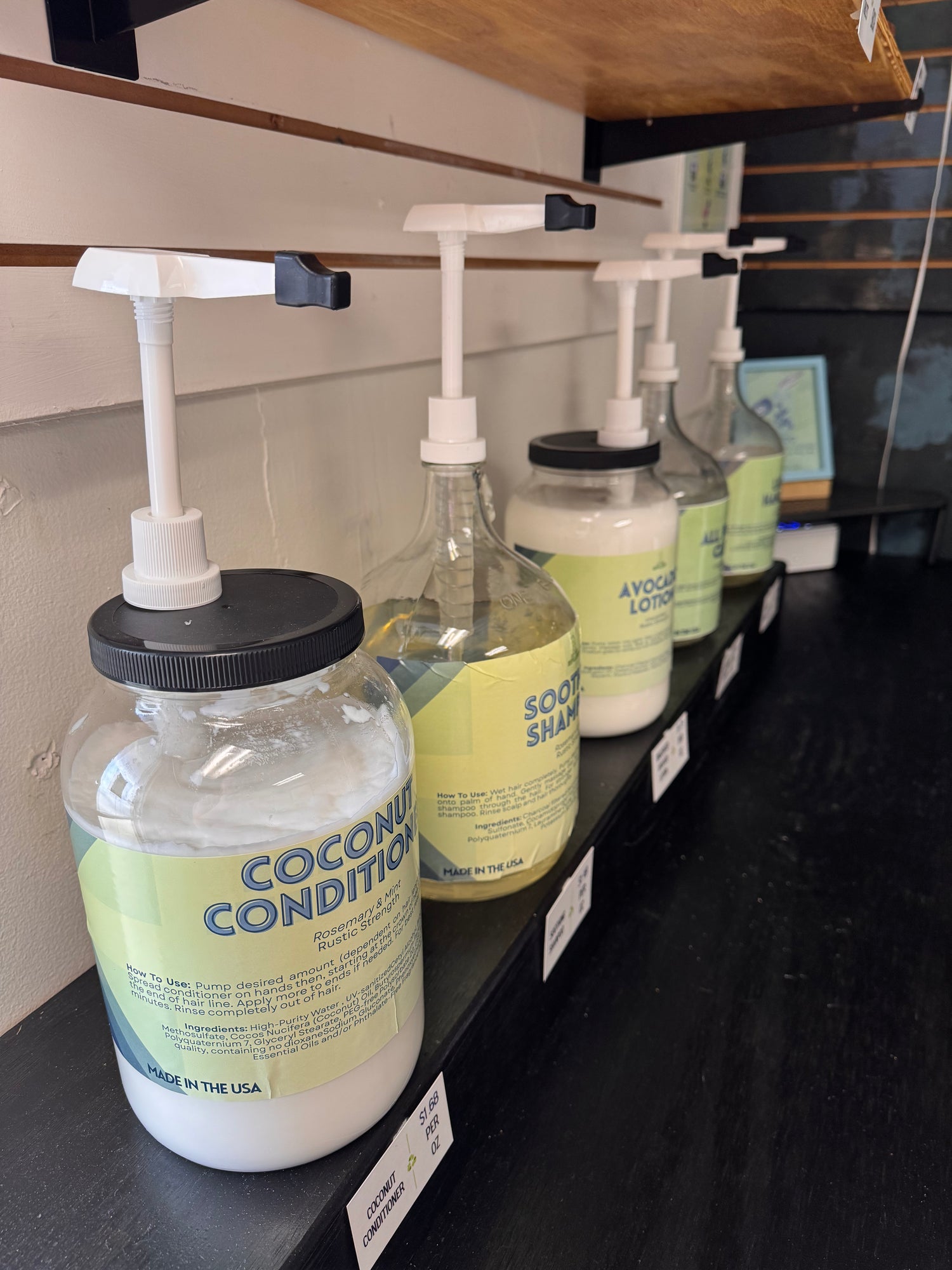 Bottles of coconut shampoo and conditioner on a shelf